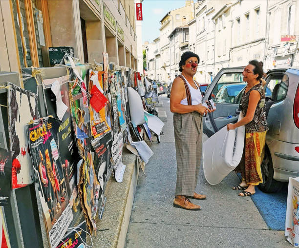 Avignon, France 28 Juillet 2019: Actor and Plenty of playbills on the walls during famous theatre festival from July 4 to 28 2019 in Avignon, south of France.