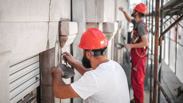 istock Two workers on the scaffolding, plastering and renovating old building 1178531266