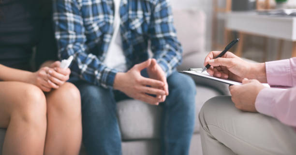istock Therapist writing hometask for psychological work to young couple 1178532748