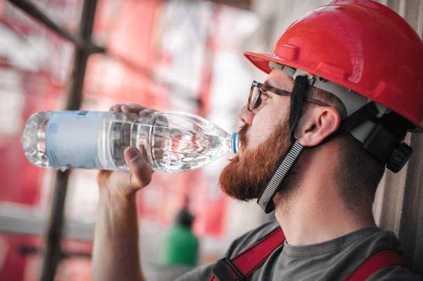 istock Construction mason worker on scaffolding, resting and drinking water 1178532847