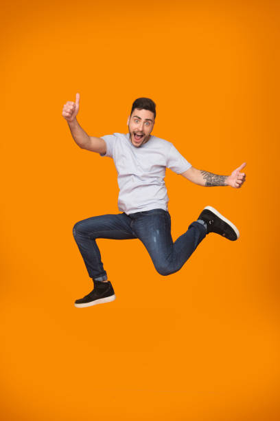 istock Overjoyed guy jumping and showing thumbs up 1178532907