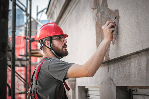 człowiek pracownik stojący na rusztowaniach i przywrócić starą fasadę budynku - cement house industry homes zdjęcia i obrazy z banku zdjęć