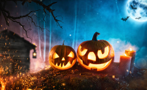 istock Spooky halloween pumpkins in dark mistery forest 1178533261