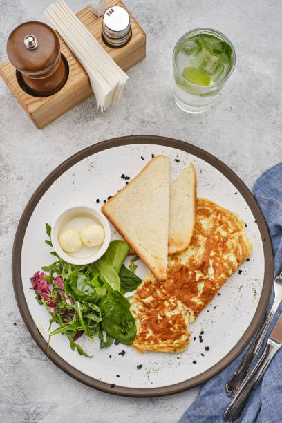 istock Omelet with herbs, bread and butter. Healthy breakfast 1178533416