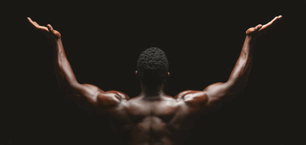 istock Rear view of african bodybuilder raising his palms up 1178534850