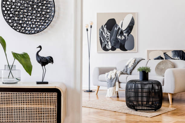 istock Scandinavian and design home interior of open space with wooden commode, gray sofa, design black rattan decoration, tropical leafs and elegant personal accessories. Stylish art home decor. Template. 1178534929