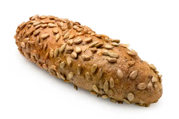 Long whole wheat bread roll with sunflower seeds isolated on white.