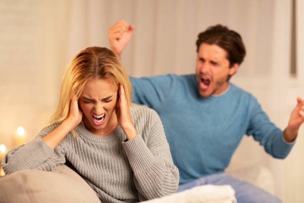 istock Abusive Husband Shouting At Wife Sitting On Couch At Home 1178536109