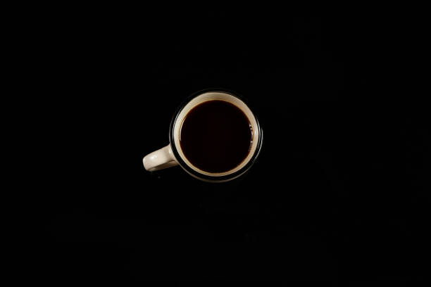 istock beige coffee Cup on a black isolated background. on black glass 1178536122