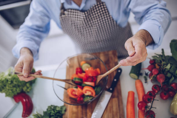 istock An old chef prepares a vegetarian lunch in a white kitchen 1178537999