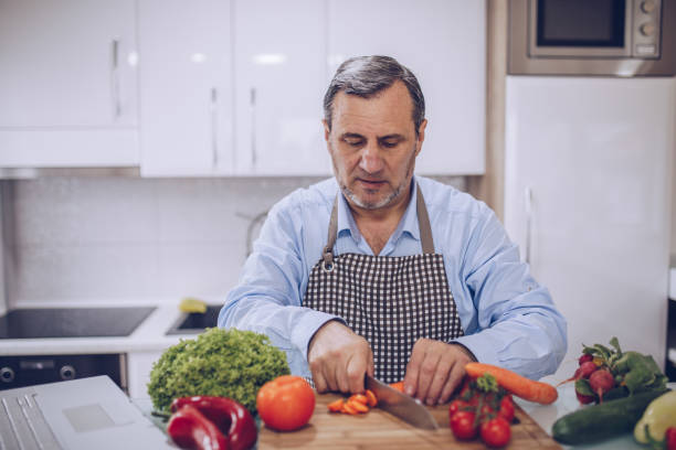 istock An old chef prepares a vegetarian lunch in a white kitchen 1178538870