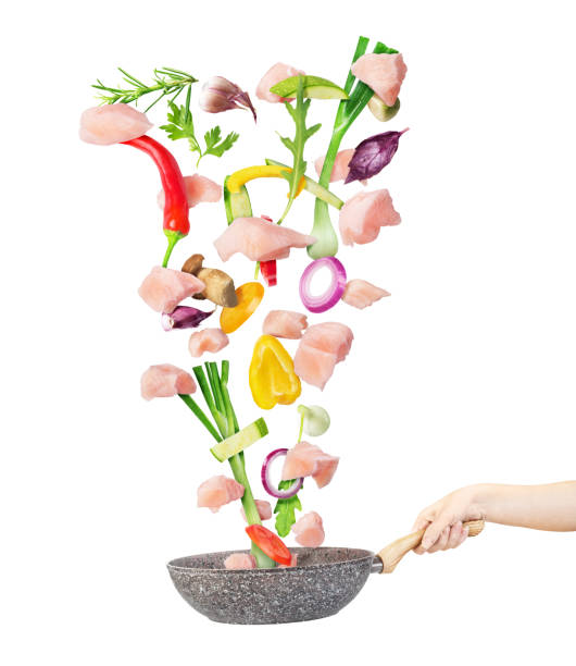 istock Cooking concept. Vegetables and meat are falling on a pan isolated on white background. Healthy food. 1178539040