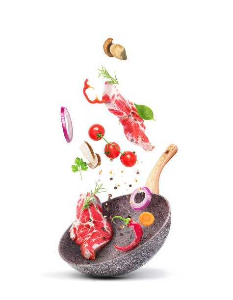 istock Cooking concept. Vegetables and meat are falling on a pan isolated on white background. Healthy food. 1178539063