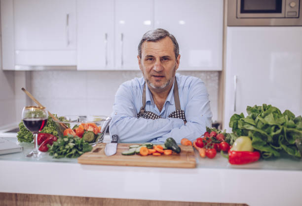 istock An old chef prepares a vegetarian lunch in a white kitchen 1178539157