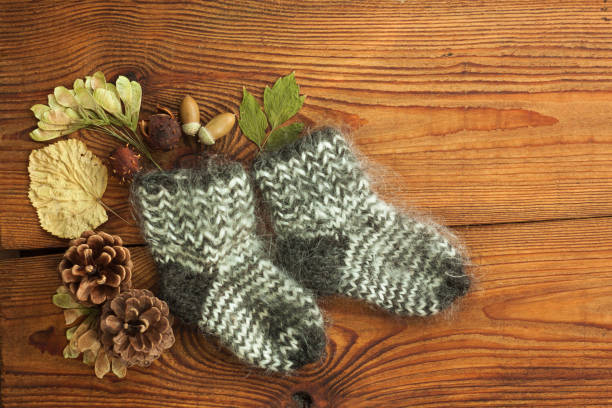 istock Hygge flatlay. Woolen socks on a wooden background top view with copy space. 1178539206