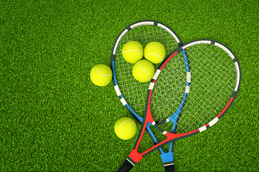 3d rendering of two tennis rackets and yellow tennis balls on green grass background. Games and sports. Outdoor activities. Sporting goods.