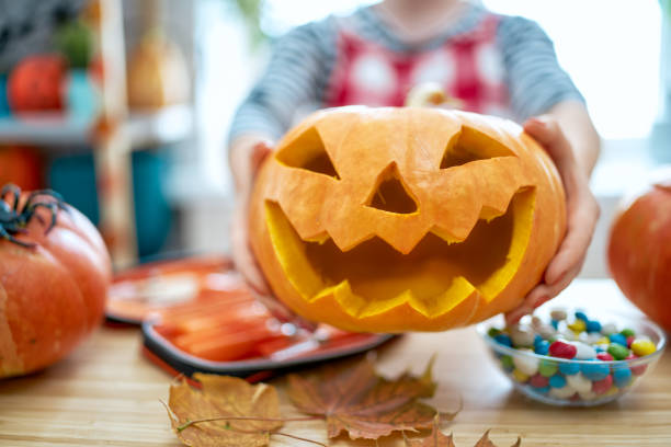 istock Woman is carving pumpkin 1178540538