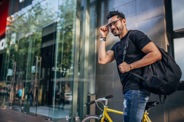 istock Handsome man riding bicycle in city 1178540673