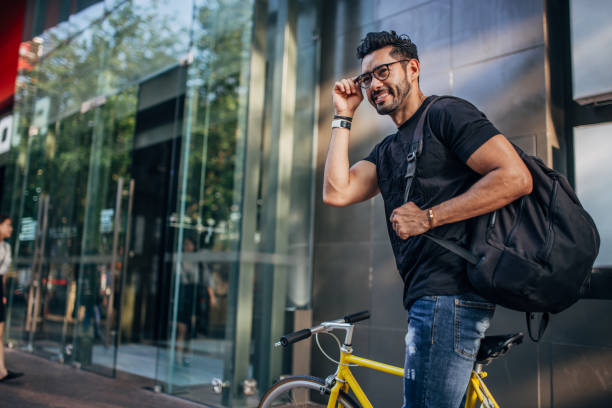 Modern guy riding bicycle in city