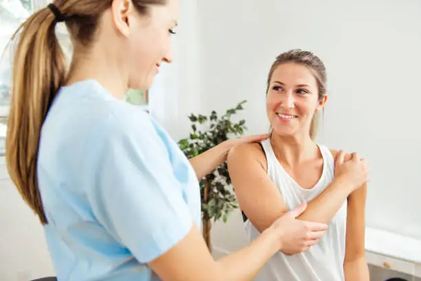 Photo of A Modern rehabilitation physiotherapist at work with client