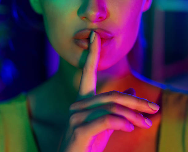 istock Silent gesture. Woman holding finger on lips 1178542134