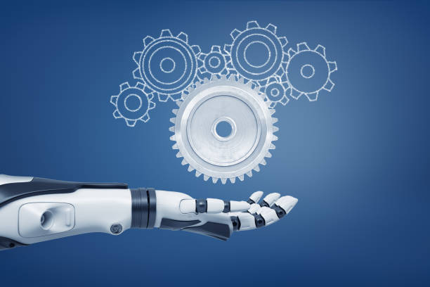 istock 3d rendering of a robot hand with its palm open and ready to catch a light-grey metal cogwheel and unfilled cogwheels of various shapes. 1178542371