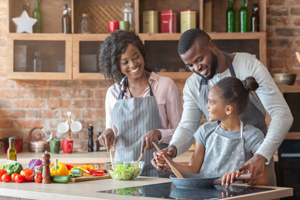 istock Young parents teaching daughter how to cook 1178542443