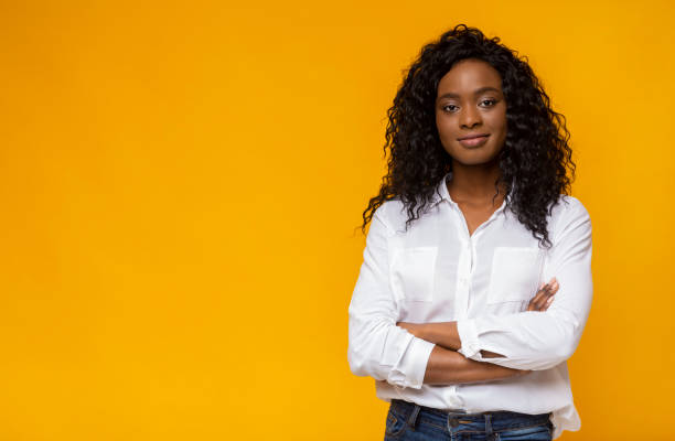 confident young african woman posing on yellow studio background - sensuality horizontal indoors studio shot imagens e fotografias de stock