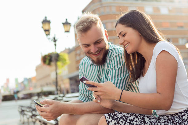 istock Beautiful couple in modern urban environment using phone together 1178544679