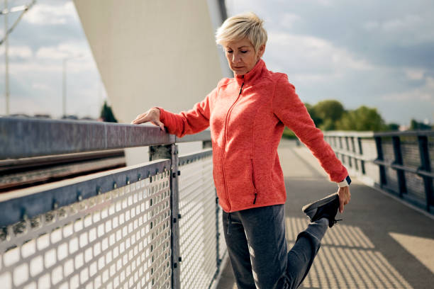 istock Happy athletic senior woman stretching before run 1178544933