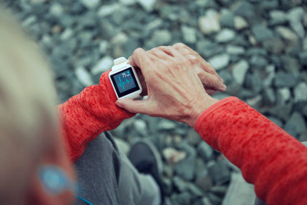istock Athletic senior woman using smart watch resting after jogging 1178544959