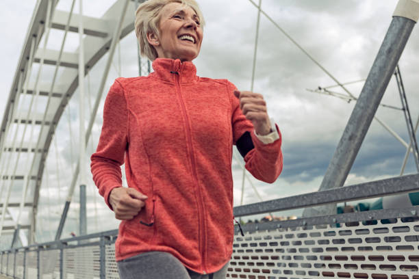 istock Smiling senior woman running 1178544978