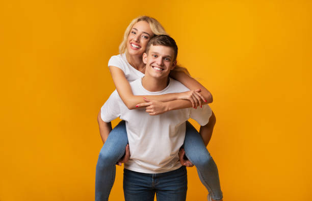 istock Piggyback ride. Young man carrying girlfriend on his back. 1178545063