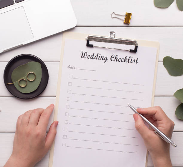 istock Woman writing wedding checklist on workplace at home 1178545076