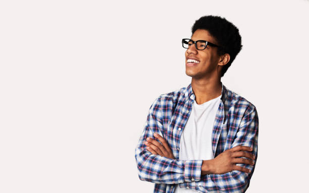 istock Excited student looking aside with crossed hands, light background 1178546638