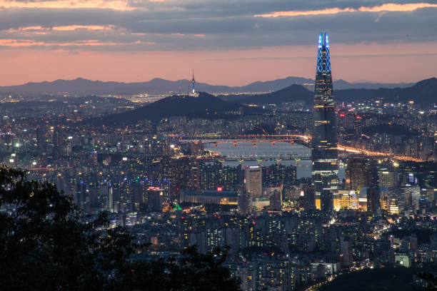 Futuristic cityscape, crowded skyscrapers illuminated at night, Seoul,  South Korea