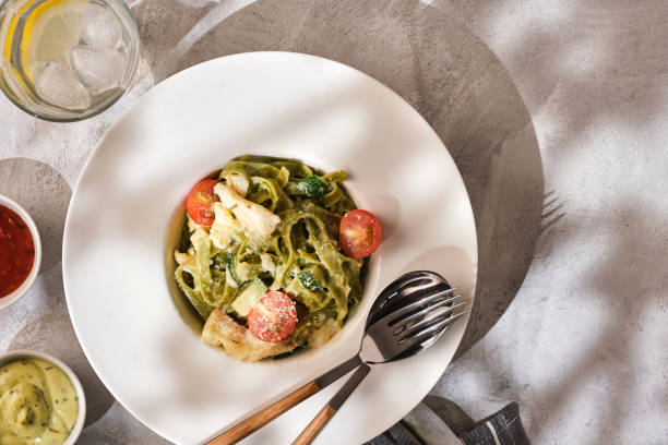 istock Homemade Tagliatelle pasta with zucchini, tomatoes and cod 1178546824