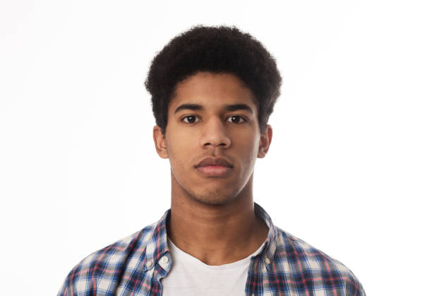 Portrait of serious african guy looking at camera over white background