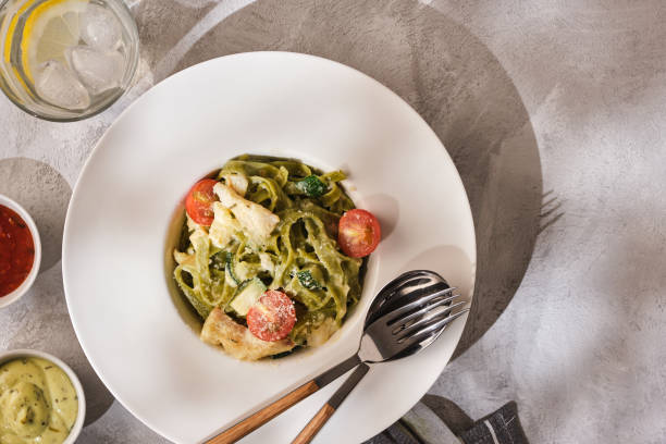istock Homemade Tagliatelle pasta with zucchini, tomatoes and cod 1178546970
