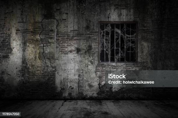 Window And Rusty Bars Covered With Cob Web Or Spider Web On Prison Old Bricks Wall And Dusty Floor Stock Photo - Download Image Now