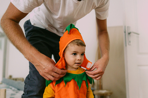 Photo of cute little boy costumed as a pumpkin is ready for Halloween