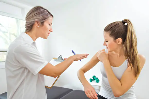 Photo of A Modern rehabilitation physiotherapist at work with client