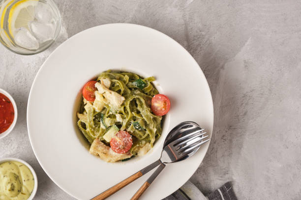 istock Homemade Tagliatelle pasta with zucchini, tomatoes and cod 1178548046
