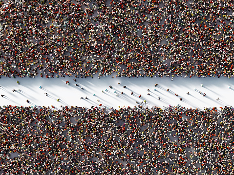 Multitud humana formando dos zonas separadas sobre fondo blanco photo