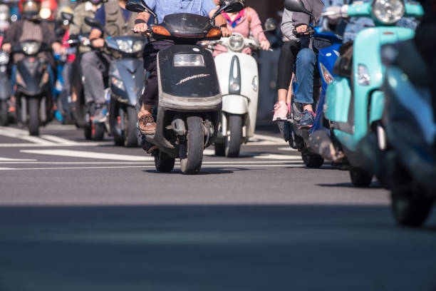 Florence, Italy - April 15, 2023: There are many scooters parked on the street in front of houses. This is a popular form of transport in the city.