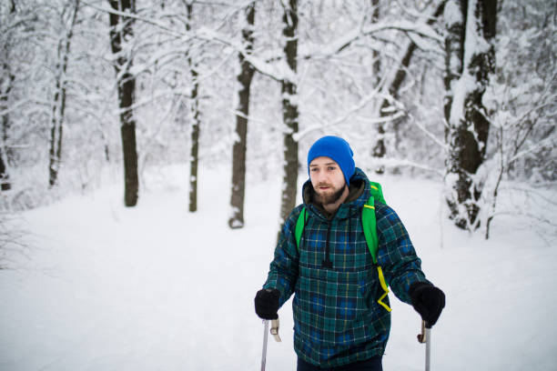 istock Man Traveler walking alone snow mountains. 1178552001
