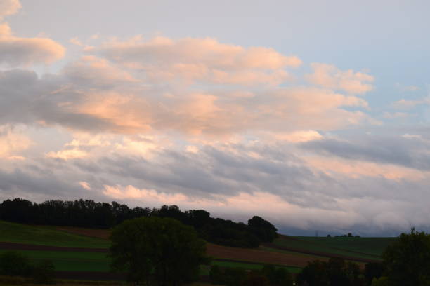 istock orange glowing clouds on rural landscape 1178552693