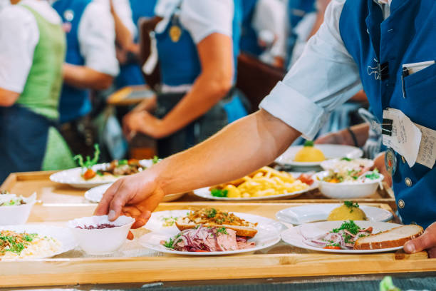 traditional Beer Fest dishes for the Guests, Munich, Germany waiters taking the plates with traditional dishes for serving to the guest of Beer Fest oktoberfest food stock pictures, royalty-free photos & images