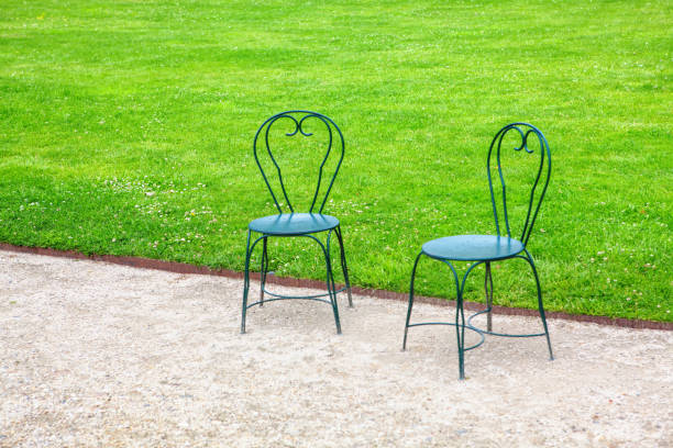 Empty metal chairs and tables in a street cafe