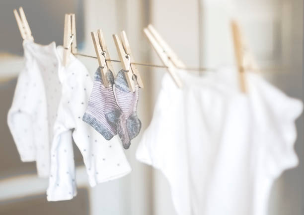 Baby clothes hanging on rope Baby clothes hanging on rope baby clothing stock pictures, royalty-free photos & images